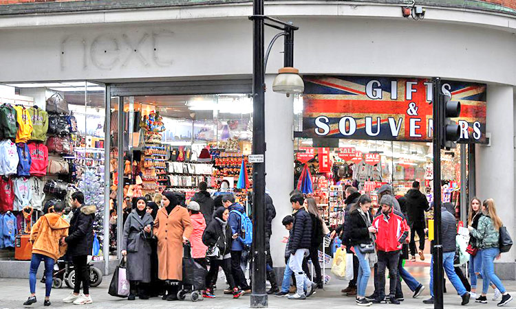 Shoppers walk past an independent gift shop on Oxford Street in London, UK.