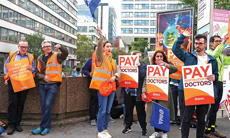 Health workers protest on a picket line as junior and senior doctors in England take part in a joint strike action for the first time, outside St Thomas’s Hospital  in London, Britain, on Wednesday.  Reuters