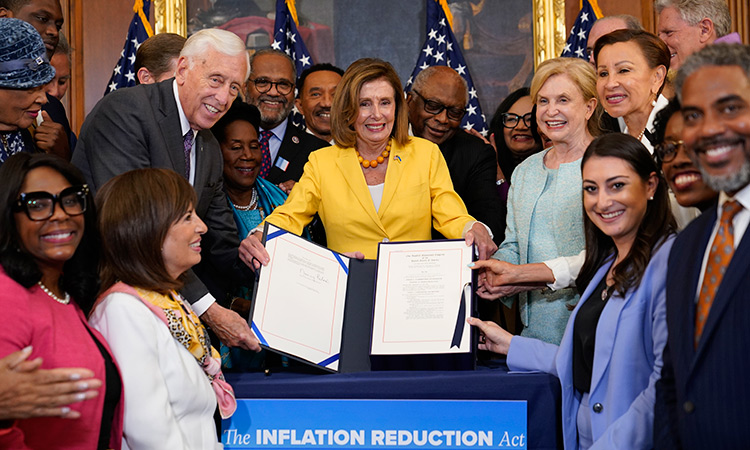 House Speaker Nancy Pelosi of California, and the House Democrats with her, celebrate after she signed the Inflation Reduction Act of 2022 during a bill enrollment ceremony on Capitol Hill in Washington on Aug. 12, 2022. AP