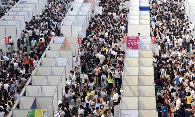 Thousands of job seekers visit booths at a job fair in Chongqing municipality. Reuters