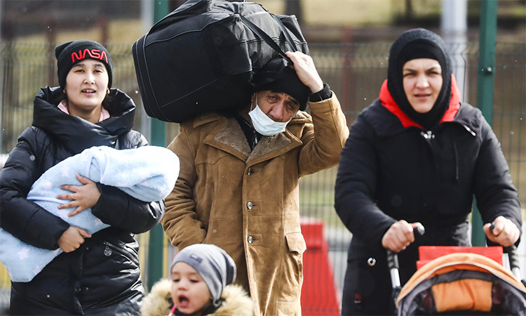 People fleeing Ukraine are seen after crossing the Ukrainian-Polish border. Beata Zawrzel. Reuters