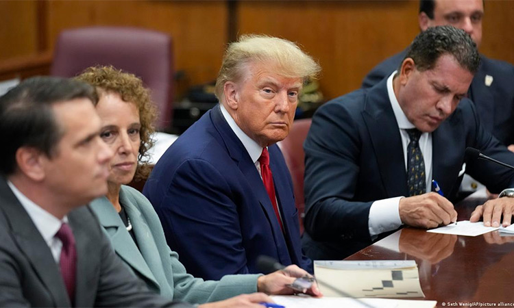Donald Trump sits at the courtroom with his legal team.
