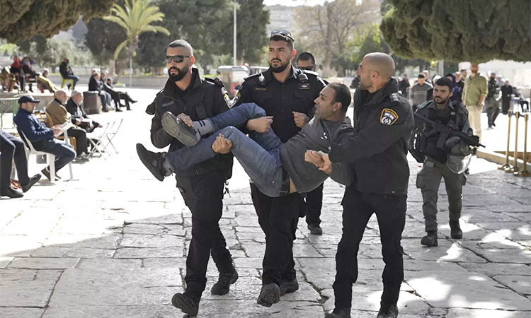 Israeli police carry off a Palestinian from the Al Aqsa Mosque compound following a raid of the site in Jerusalem’s Old City. AP
