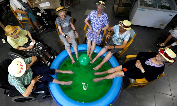Elderly residents dip their feet in a pool in Grimbergen, Belgium. An intense heatwave has gripped Europe, setting new records.  Reuters
