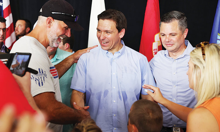 Ron DeSantis greets guest after speaking at US Rep. Zach Nunn’s (right), ‘Operation Top Nunn: Salute to Our Troops’ fundraiser in Ankeny, Iowa. Tribune News Service