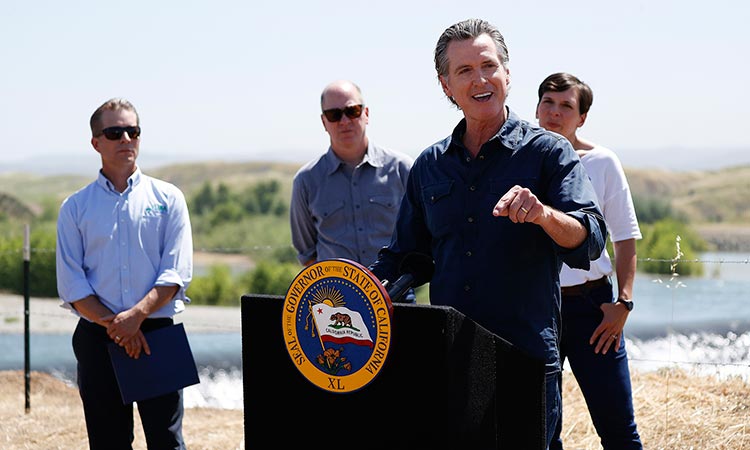 California Gov. Gavin Newsom, second from right, speaks to the media during a news conference at the Lower Yuba River and the Daguerre Point Dam on May 16, 2023, in Marysville, California.  Tribune News Service