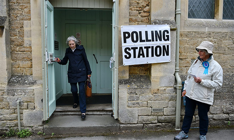 A woman exits a polling station after casting her vote.