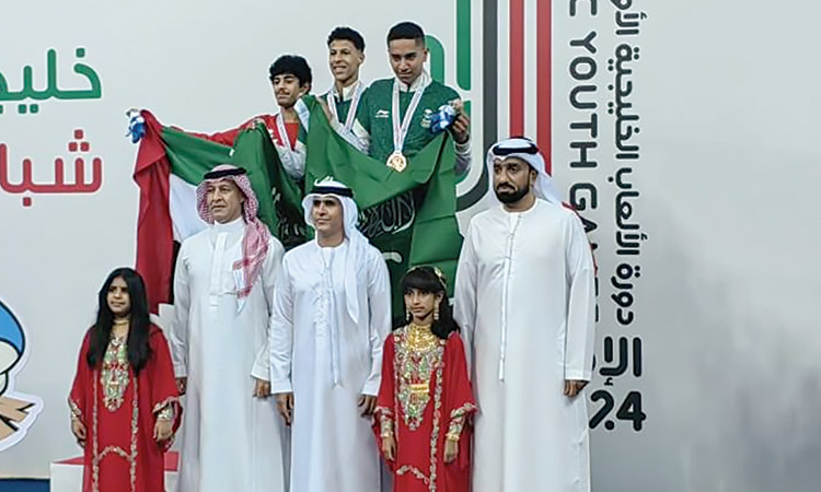 Winners of fencing competition with Faris Mohammed Al-Mutawa, Secretary General of the National Olympic Committee, and other dignitaries during the presentation ceremony.