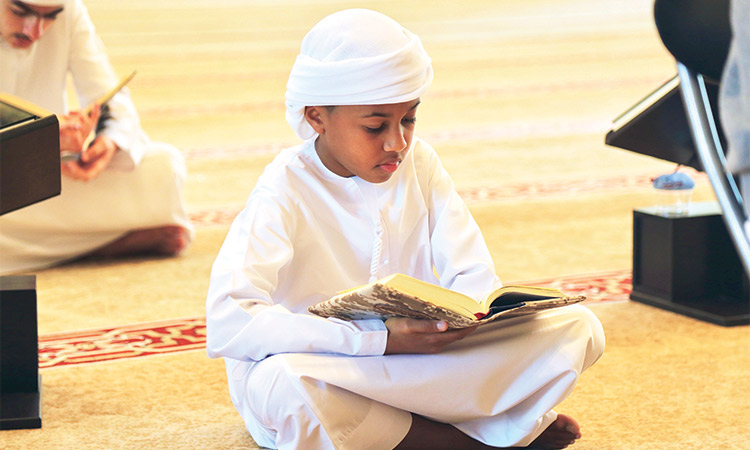A-child-sits-and-recites-Quran