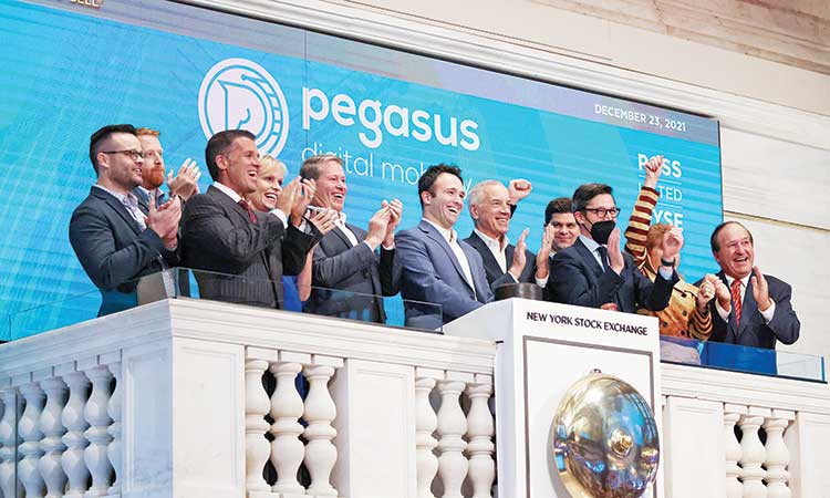 Jim Condon and Patrick Miller, Pegasus Digital Mobility board of directors members, ring the opening bell at the New York Stock Exchange on Friday.  Reuters