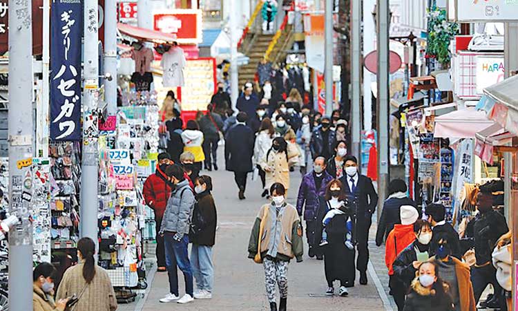 Pedestrians make their way through a shopping district in Tokyo, Japan. Reuters