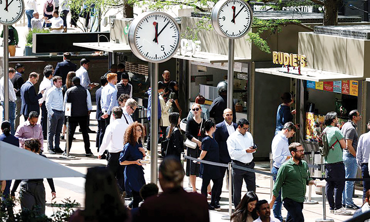 People queue for food in the financial district of Canary Wharf, London, Britain.