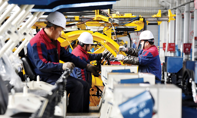 Employees work on a drilling machine production line at a factory in Zhangjiakou, China.