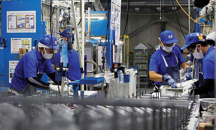 Workers are seen along the assembly line at Marelli’s factory in Ora Town, Gunma Prefecture, Japan.  Reuters