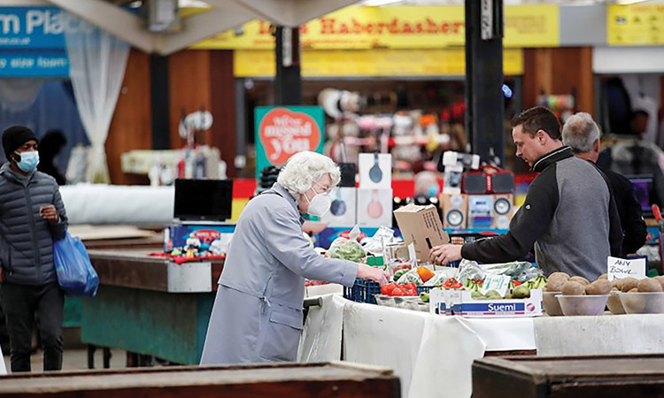 People shop at Leicester Market in Leicester, Britain.  Reuters