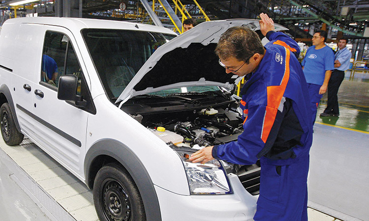 A worker checks a Ford Transit Connect car produced at the Ford factory in Craiova, Bucharest. Reuters