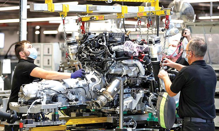 Technicians work on an engine at the production line of the Rolls-Royce Goodwood factory in Britain.  File/Reuters