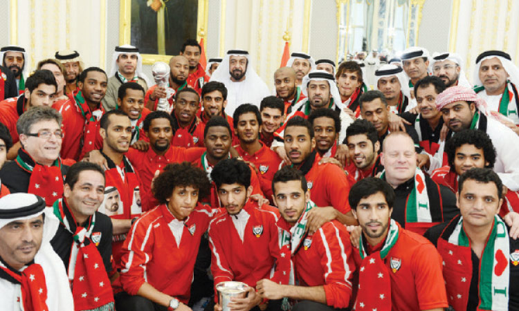 Sheikh Khalifa with members of the UAE national football team at the Al Rawda Palace in Al Ain, after they won the Gulf Cup in 2013. File / WAM