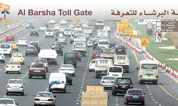 Cars drive under a ‘toll gate’ sign on Sheikh Zayed Road, one of the  busiest in Dubai.  Agence France-Presse