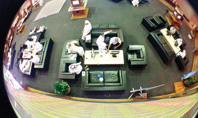 Investors work on the floor of the  Dubai Financial Market in Dubai.   Reuters