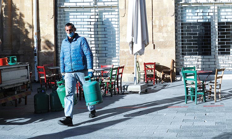 A man carries gas bottles in Nicosia, Cyprus.  File/Reuters