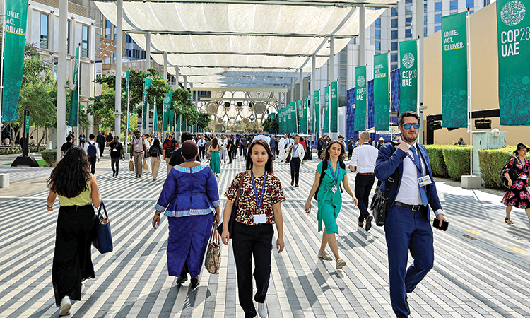 Delegates walk at the Dubai’s Expo City during the COP28 in Dubai on Monday. Reuters