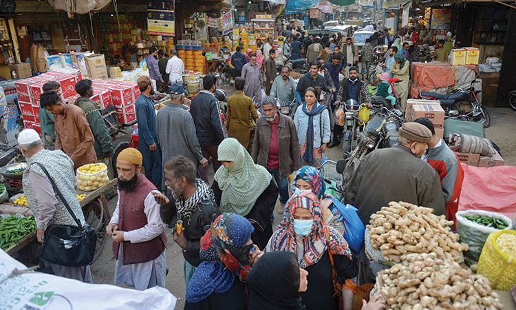 People throng a wholesale market in Karachi on Wednesday. Agence France-Presse