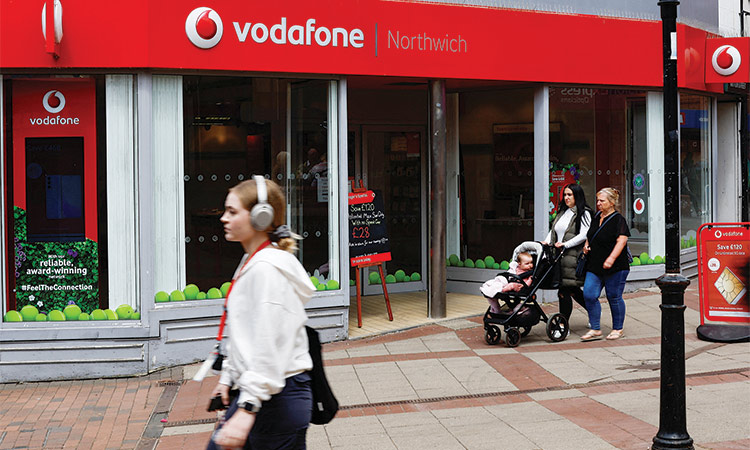 People walk past a Vodafone store in Northwich, Cheshire, Britain. Reuters