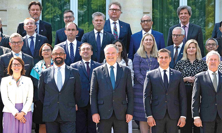 Dignitaries pose for a group photo after a press conference to present the organisation’s updated global economic outlook, in Paris, France, on Wednesday.  AFP