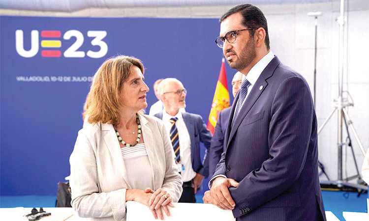 Dr Sultan Bin Ahmed Al Jaber with an official in Madrid.