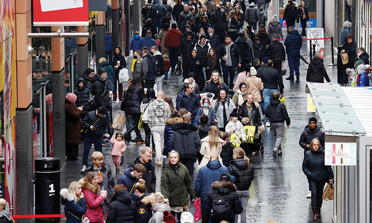 People walk along a busy street in Liverpool, Britain.  Reuters