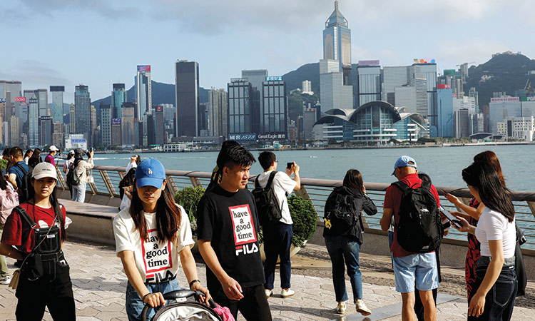 People walk in front of buildings at Tsim Sha Tsui, in Hong Kong, China. Reuters