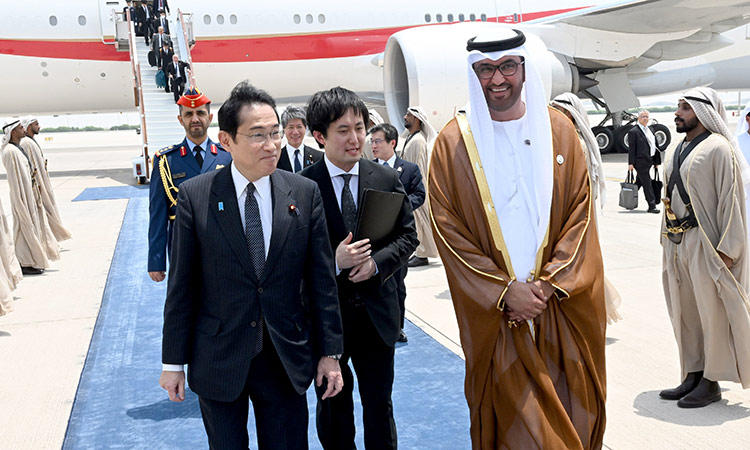 Dr Sultan Bin Ahmed Al Jaber, Minister of Industry and Technology, receives Fumio Kishida, Prime Minister of Japan, upon his arrival at the Presidential Airport in Abu Dhabi on Monday.  WAM
