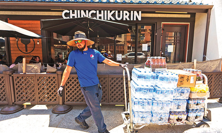 A man delivers beverages in the Little Tokyo district of Los Angeles. File/ Associated Press