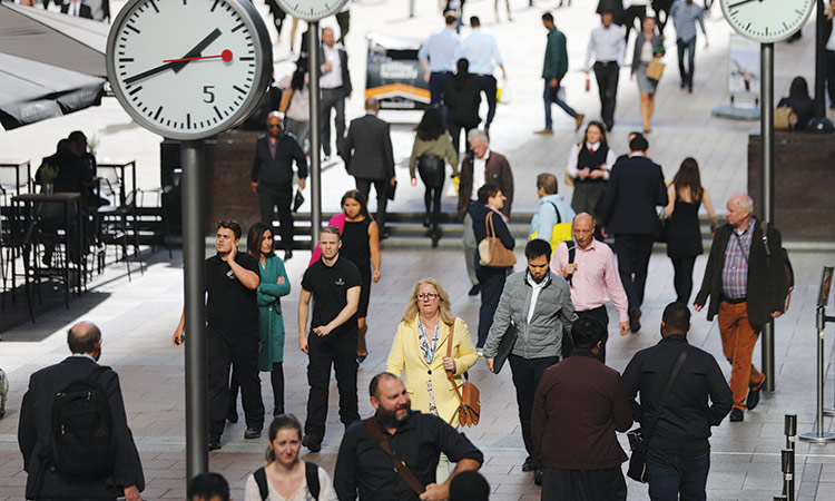 People walk through the financial district of Canary Wharf, London. File/Reuters