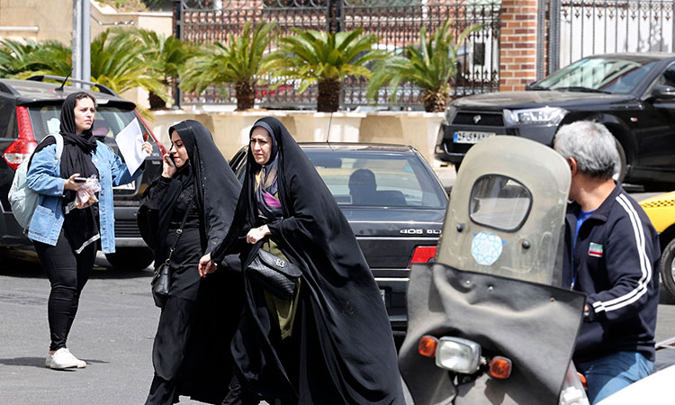 A woman walks in a street in Tehran on Monday. Police said they plan to use 'smart' technology in public places to identify and then penalise women who violate the dress code. Agence France-Presse
