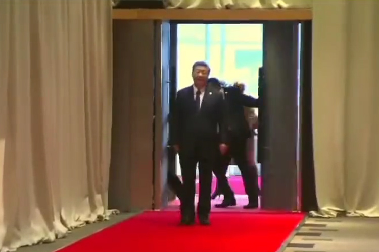 A videograb shows a guard closing the door behind Xi Jinping.