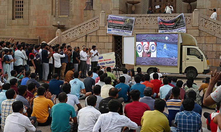 Students and staff members watch live telecast of lunar landing of Chandrayaan-3 spacecraft on the south pole of the Moon, at Osmania University in Hyderabad on Wednesday. AFP