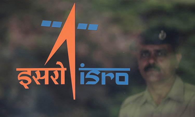 A security guard stands behind the logo of Indian Space Research Organisation (ISRO) at its headquarters in Bengaluru. file / Reuters