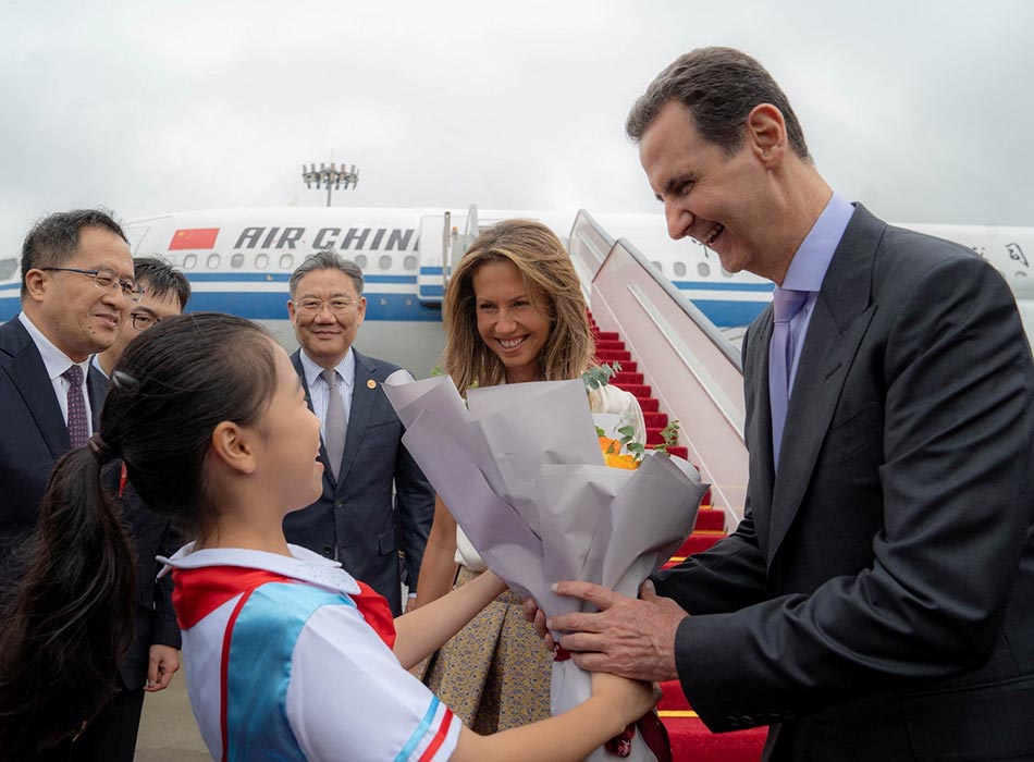  Bashar Al Assad and his wife Asma are welcomed upon their arrival at Hangzhou airport, China, on Thursday. Reuters