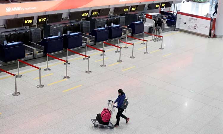 A passenger moves through an empty check-in area at the Beijing International Airport during lockdown in the city. Reuters