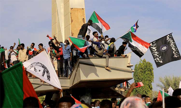 People celebrate after reaching the presidential palace, protesting against military rule following last month's coup in Khartoum, Sudan. Reuters