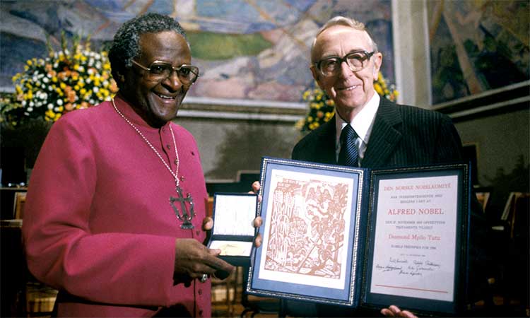 Desmond Tutu (left) is presented with the Nobel Peace prize by chairman of the Nobel Committee, Egil Aarvik, in the University’s auditorium in Oslo, Norway.   File/Associated Press