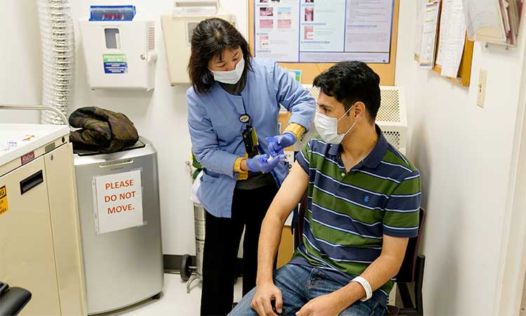 A newly arrived refugee from Afghanistan receives a vaccination from clinical nurse Catherine Pham at the Valley Health Centre TB/Refugee Programme in San Jose, California. 