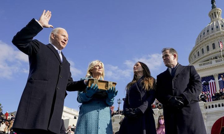  Joe Biden is sworn in as the 46th president of the United States by Chief Justice John Roberts as Jill Biden holds the Bible at the US Capitol in Washington. File/Associated Press