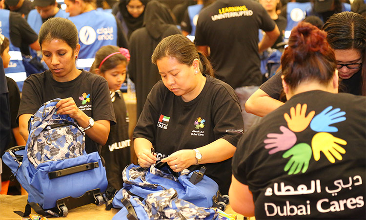 Volunteers at a Dubai Cares facility ready school kits to be distributed to orphan children. WAM