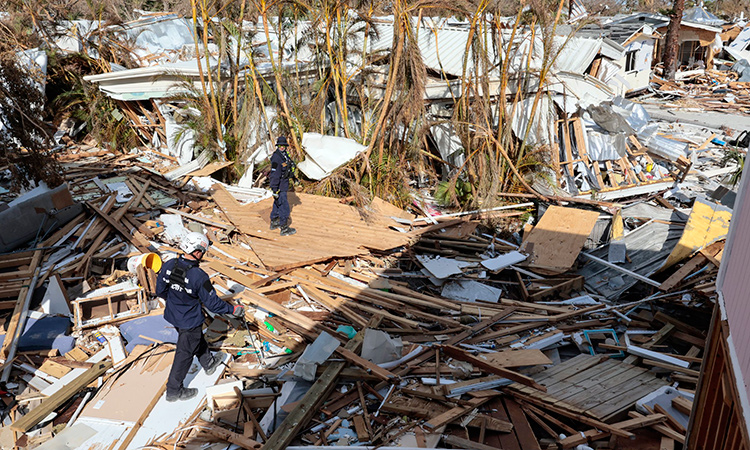Urban Search and Rescue Florida Task Force 2 personnel search the damaged homes on Fort Myers Beach. Tribune News Service