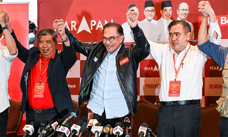 Anwar Ibrahim (center) reacts at the end of a press conference in Kuala Lumpur. AFP