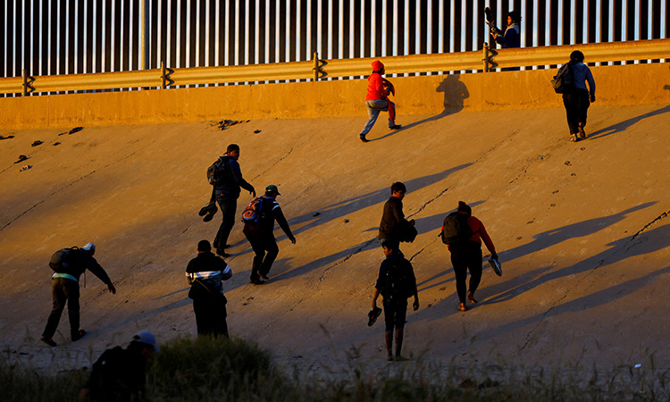 Asylum-seeking migrants cross the Rio Bravo river to turn themselves in to US Border Patrol agents to request asylum in El Paso as seen from Ciudad Juarez, Mexico on Tuesday. Reuters