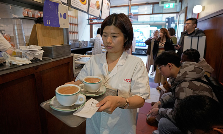 A waitress serves Hong Kong-style milk tea at the HOKO Cafe, a pop-up cafe in the trendy London neighbourhood of Shoreditch that’s attracting Londoners and tourists as well as Hong Kong emigres. AP